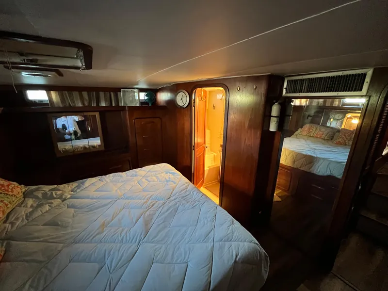 Slide: The Image of Cozy bedroom interior of 1980 Gulfstar Trawler with wood paneling and soft lighting. - 45