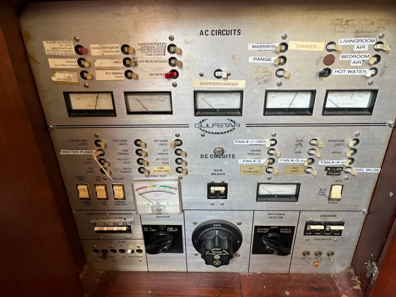 Slide: The Image of Control panel of a 1980 Gulfstar Trawler with AC and DC circuit switches. - 6
