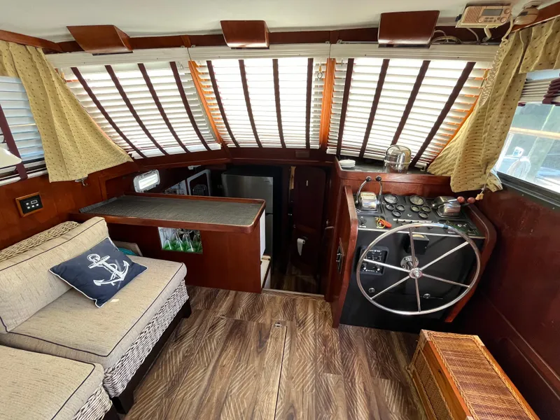 Slide: The Image of 1980 Gulfstar Trawler interior with helm, seating, and nautical decor. - 9