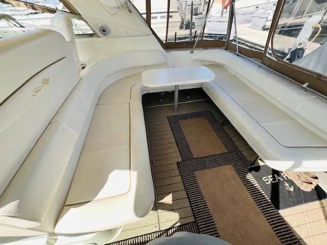 Slide: The Image of 1999 Sea Ray 400 Sundancer interior with white seating and table. - 10