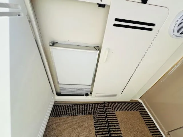 Slide: The Image of Interior view of 1999 Sea Ray 400 Sundancer with white cabinetry and patterned carpet. - 13