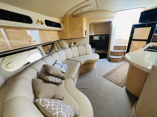 Slide: The Image of Luxurious interior of a 1999 Sea Ray 400 Sundancer yacht with plush seating and modern amenities. - 16