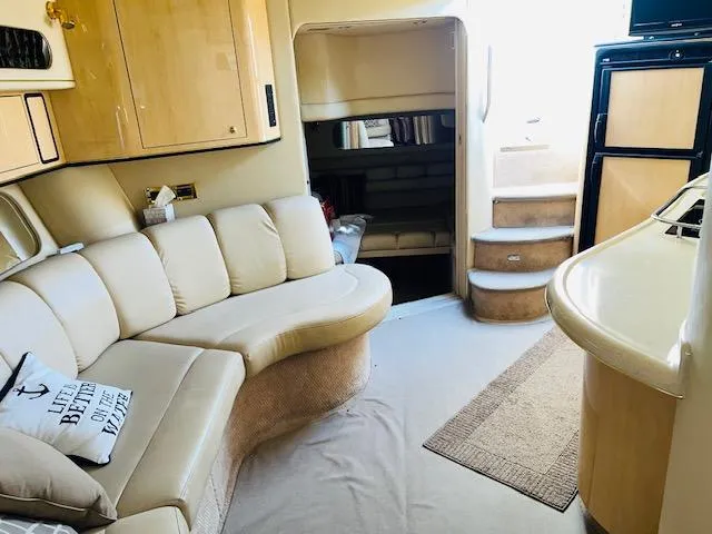 Slide: The Image of Interior of 1999 Sea Ray 400 Sundancer yacht with beige seating and compact design. - 19