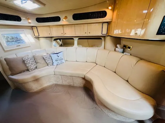 Slide: The Image of Luxurious interior of 1999 Sea Ray 400 Sundancer with cream leather seating and elegant decor. - 20