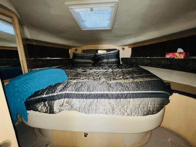Slide: The Image of 1999 Sea Ray 400 Sundancer cabin with cozy bed and skylight. - 26