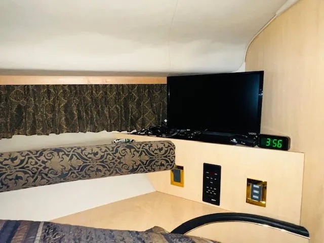 Slide: The Image of Interior cabin of 1999 Sea Ray 400 Sundancer with TV and clock. - 28