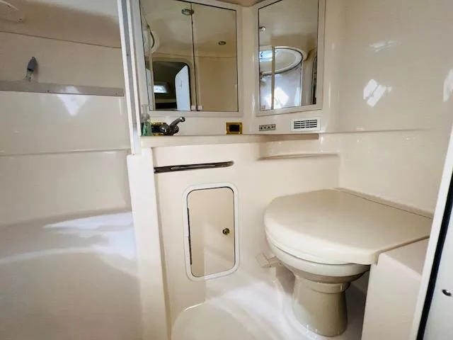 Slide: The Image of Bathroom interior of 1999 Sea Ray 400 Sundancer yacht, featuring toilet and sink. - 29