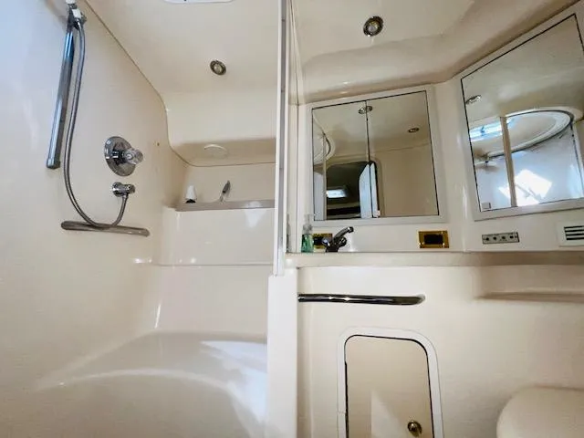 Slide: The Image of Bathroom interior of 1999 Sea Ray 400 Sundancer yacht, featuring shower and mirrored cabinets. - 30