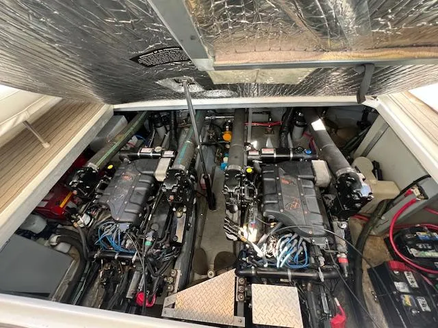 Slide: The Image of Engine room of a 1999 Sea Ray 400 Sundancer with dual engines and equipment. - 31
