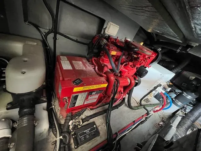 Slide: The Image of Engine room of a 1999 Sea Ray 400 Sundancer with visible red machinery. - 32