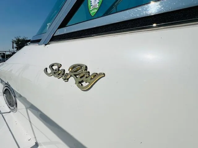 Slide: The Image of 1999 Sea Ray 400 Sundancer boat with logo on white exterior. - 6