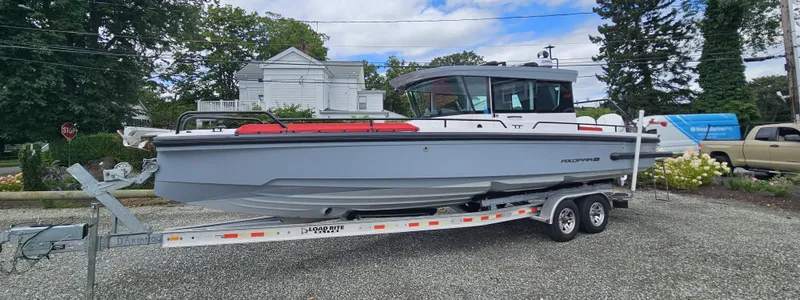 Slide: The Image of 2022 Axopar 28 boat on trailer, parked outdoors. - 1