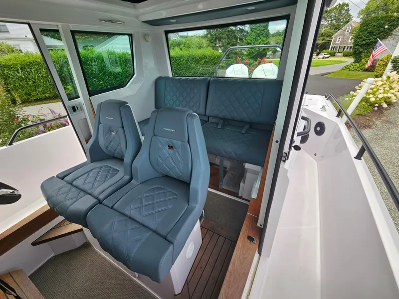 Slide: The Image of Interior of 2022 Axopar 28 boat with blue quilted seats. - 18