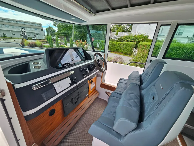 Slide: The Image of Interior of 2022 Axopar 28 boat with modern dashboard and comfortable seating. - 22