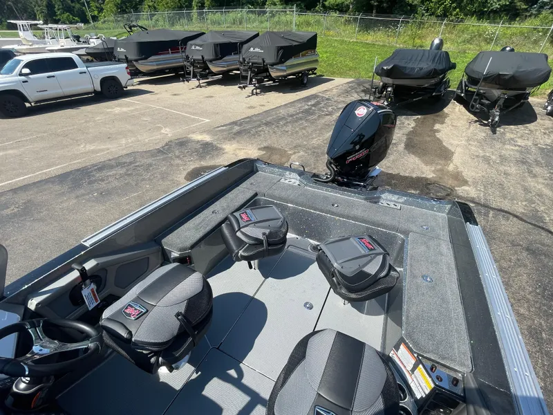 Slide: The Image of 2025 Ranger 620FS Ranger Cup Equipped boat in parking lot with covered boats and truck nearby. - 5