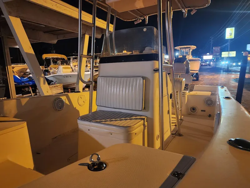Slide: The Image of 2005 Sea Hunt Navigator 22 boat interior at night, showcasing seating and console. - 11