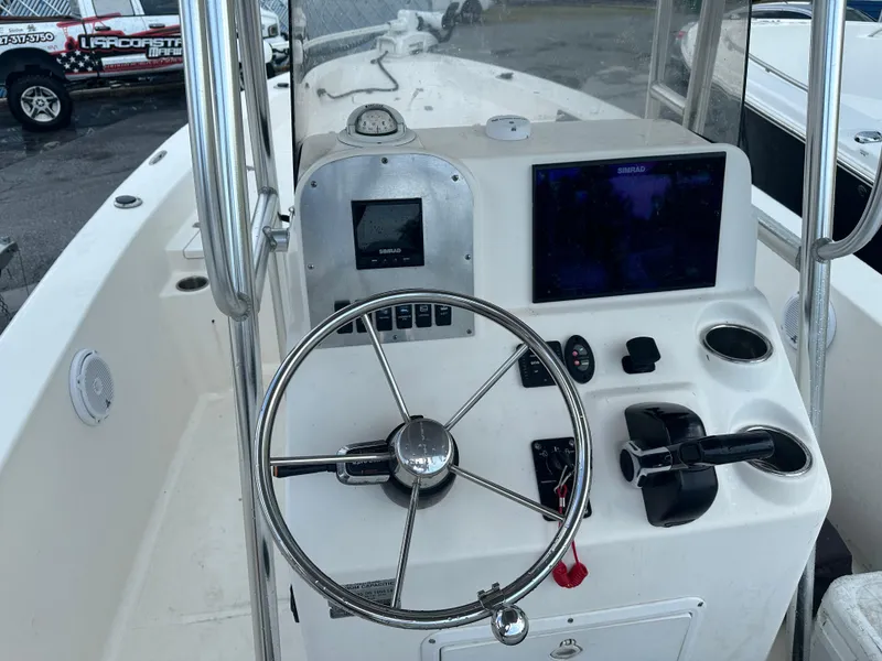 Slide: The Image of 2005 Sea Hunt Navigator 22 boat console with steering wheel and navigation equipment. - 12
