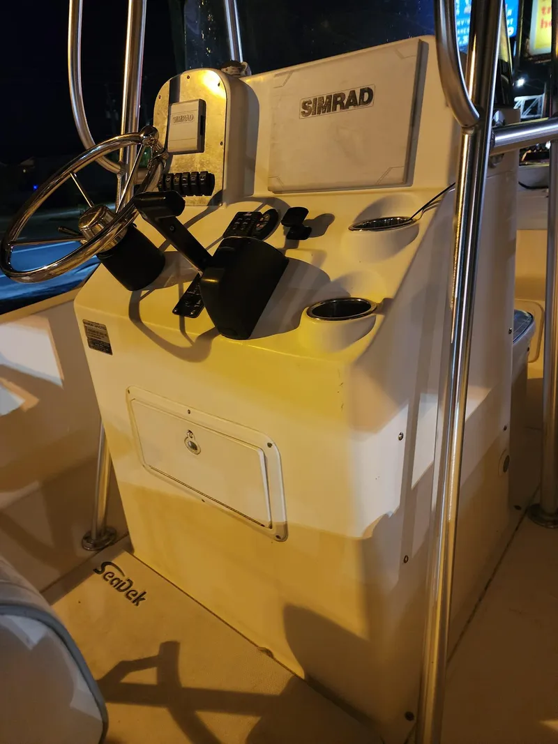 Slide: The Image of 2005 Sea Hunt Navigator 22 boat console with Simrad electronics at night. - 17