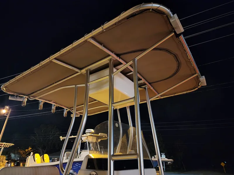 Slide: The Image of 2005 Sea Hunt Navigator 22 boat with T-top at night. - 19