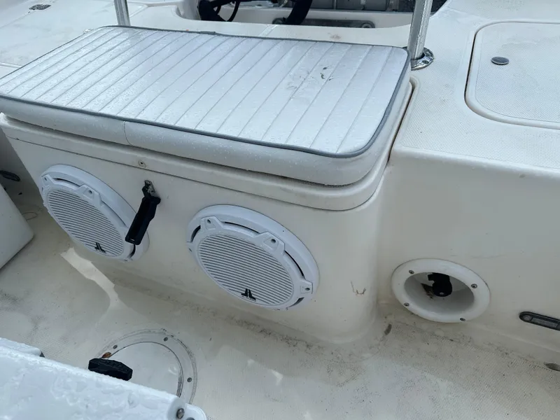 Slide: The Image of 2005 Sea Hunt Navigator 22 boat interior with speakers and seating. - 26