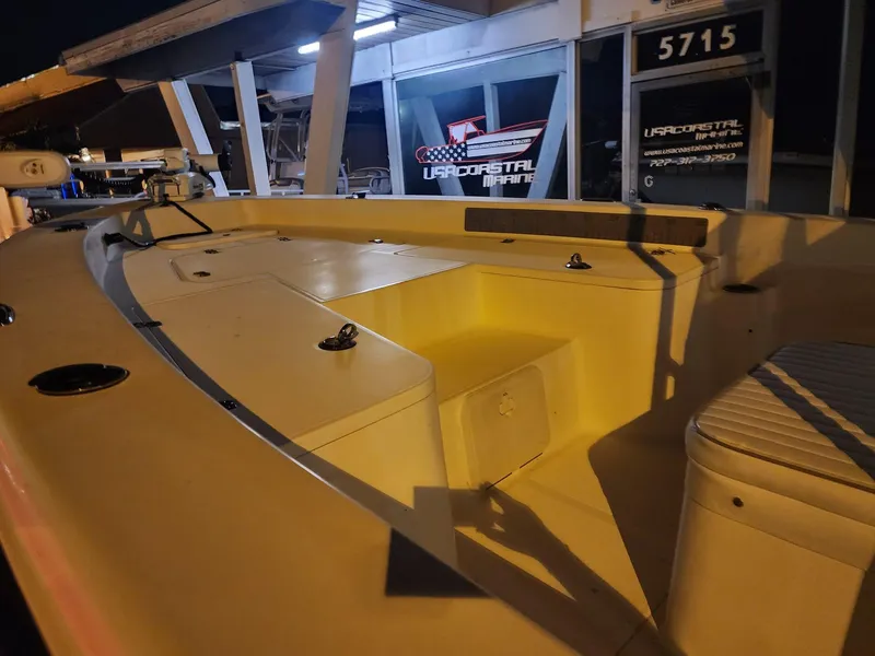 Slide: The Image of 2005 Sea Hunt Navigator 22 boat interior at night, showcasing seating and storage. - 27