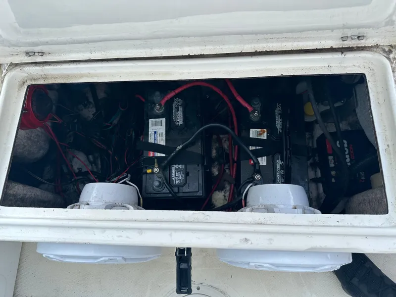 Slide: The Image of 2005 Sea Hunt Navigator 22 battery compartment with wiring and components. - 28