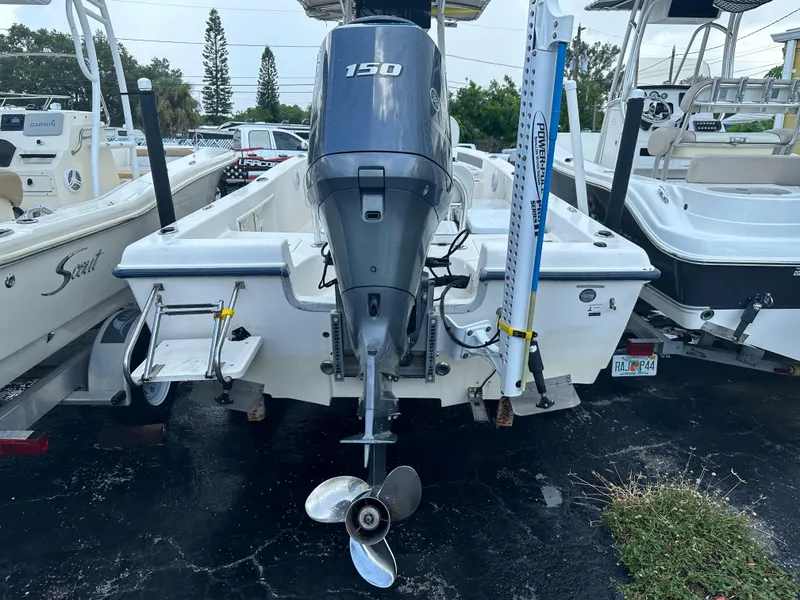 Slide: The Image of 2005 Sea Hunt Navigator 22 boat with 150 HP outboard motor, docked in a marina. - 6