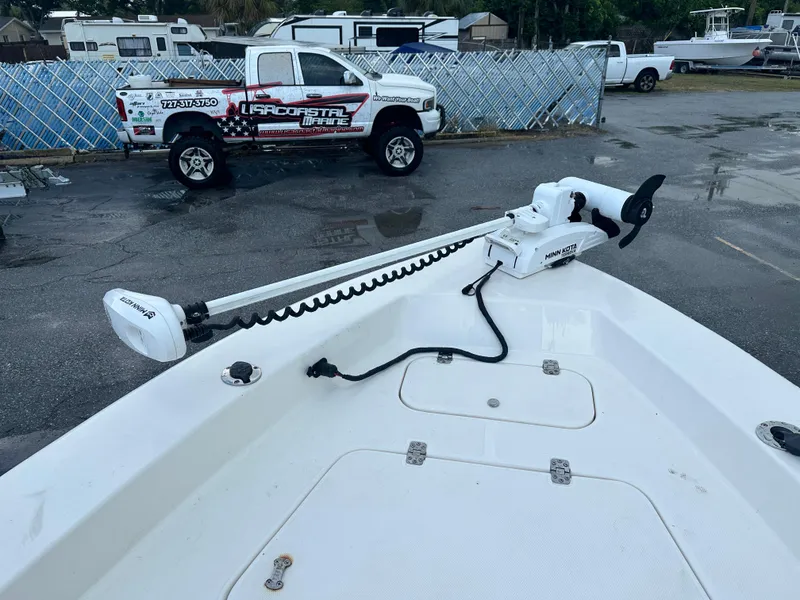 Slide: The Image of Sea Hunt Navigator 22 boat with trolling motor, parked near a truck, 2005 model. - 8