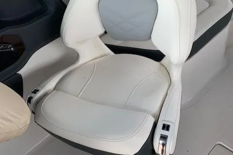 Slide: The Image of White leather seat in 2022 Chaparral 267 SSX OB boat interior. - 10