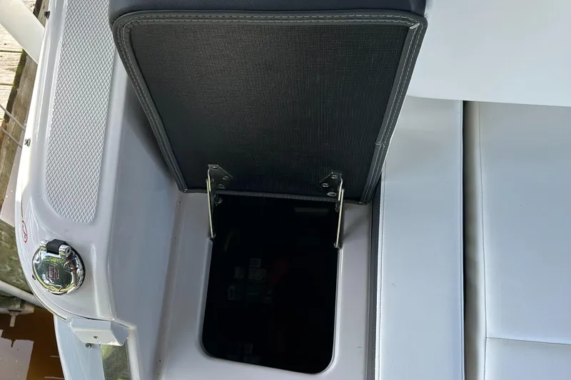 Slide: The Image of Open storage compartment on 2022 Chaparral 267 SSX OB boat. - 15
