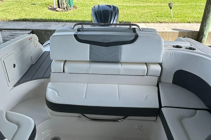 Slide: The Image of 2022 Chaparral 267 SSX OB boat interior with white seating and sleek design. - 18