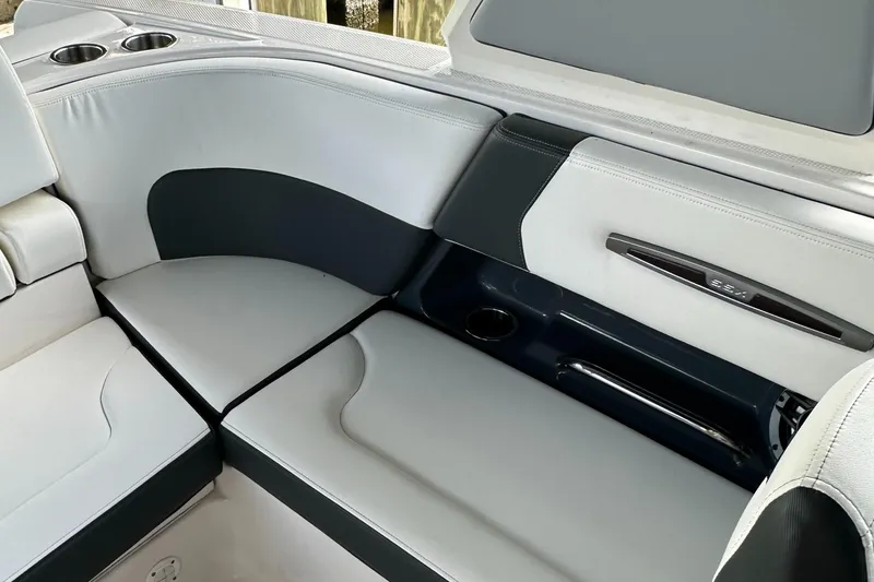 Slide: The Image of 2022 Chaparral 267 SSX OB boat interior with sleek seating and cup holders. - 19