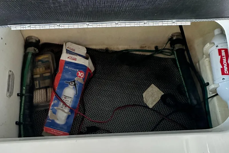 Slide: The Image of Storage compartment of 2022 Chaparral 267 SSX OB with marine equipment and fire extinguisher. - 20