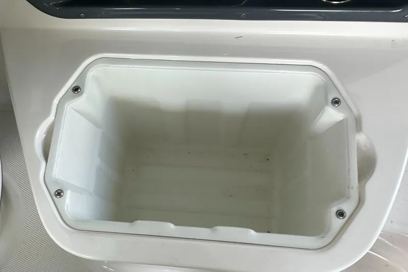 Slide: The Image of Chaparral 267 SSX OB 2022 boat storage compartment, white interior, close-up view. - 24