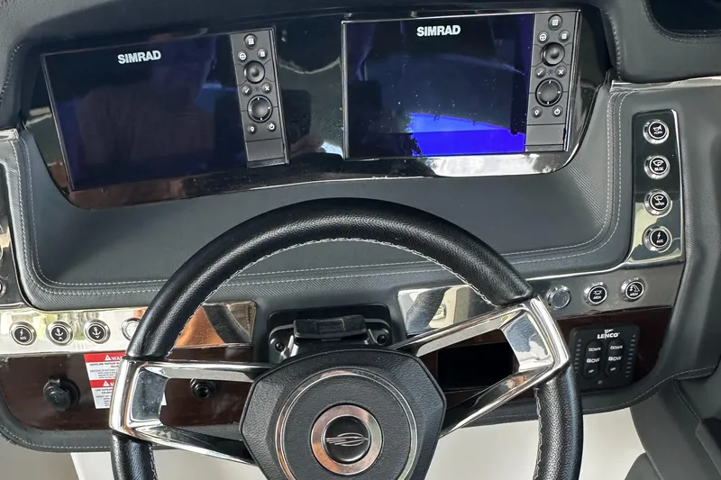 Slide: The Image of 2022 Chaparral 267 SSX OB dashboard with dual Simrad displays and sleek steering wheel. - 26