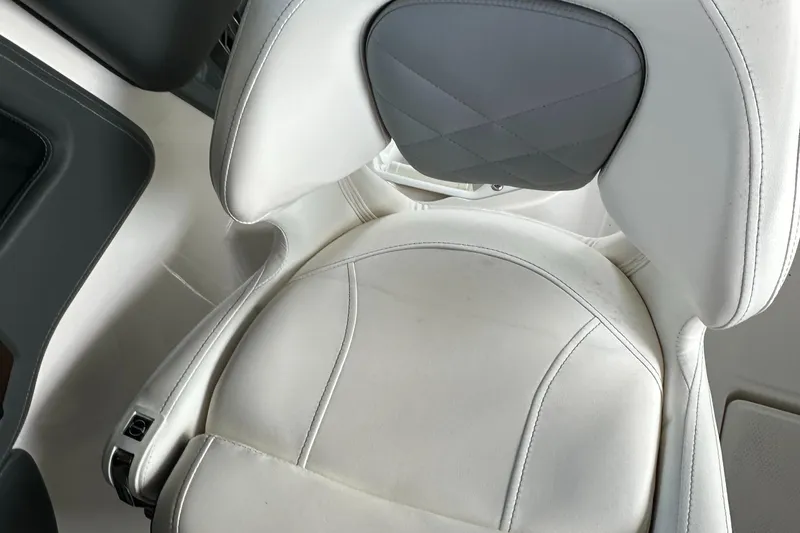 Slide: The Image of 2022 Chaparral 267 SSX OB boat seat, white and gray upholstery, close-up view. - 28