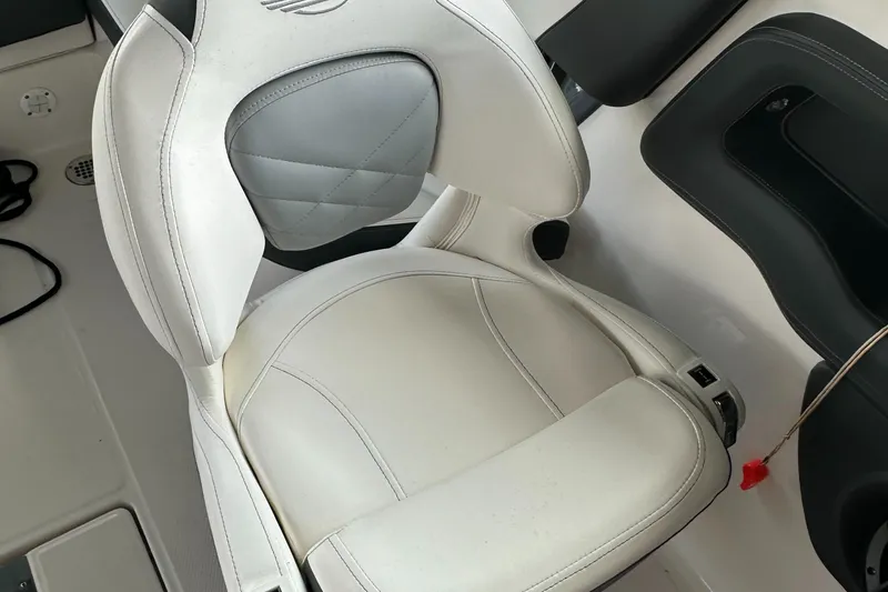 Slide: The Image of 2022 Chaparral 267 SSX OB boat seat with white and gray upholstery. - 30