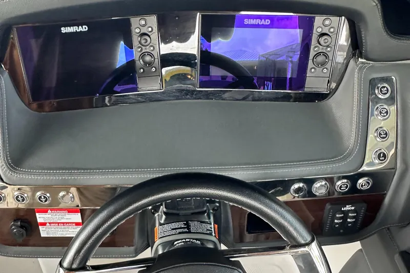 Slide: The Image of 2022 Chaparral 267 SSX OB dashboard with dual Simrad displays and control panel. - 36