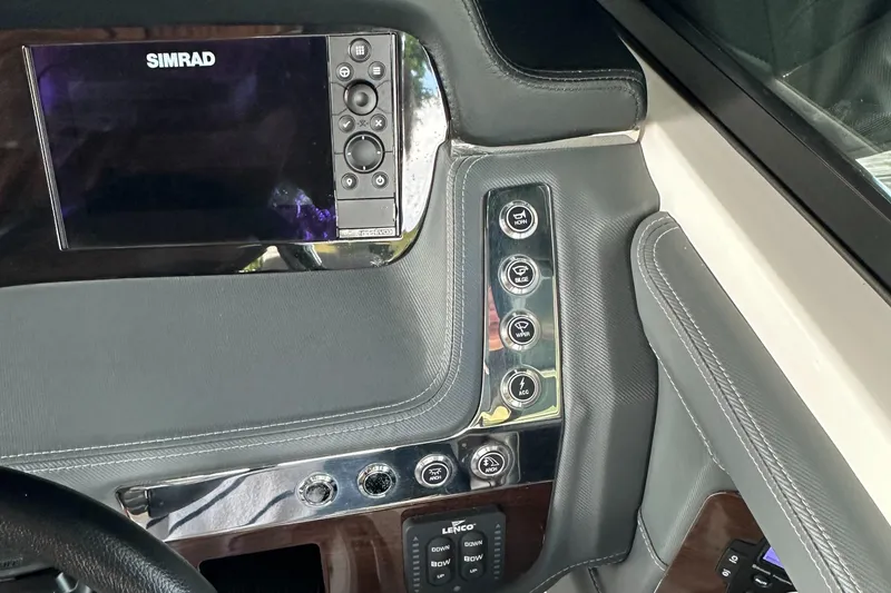 Slide: The Image of 2022 Chaparral 267 SSX OB dashboard with Simrad display and control panel. - 37