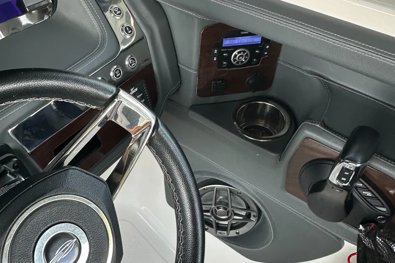 Slide: The Image of 2022 Chaparral 267 SSX OB boat dashboard with steering wheel and controls. - 38