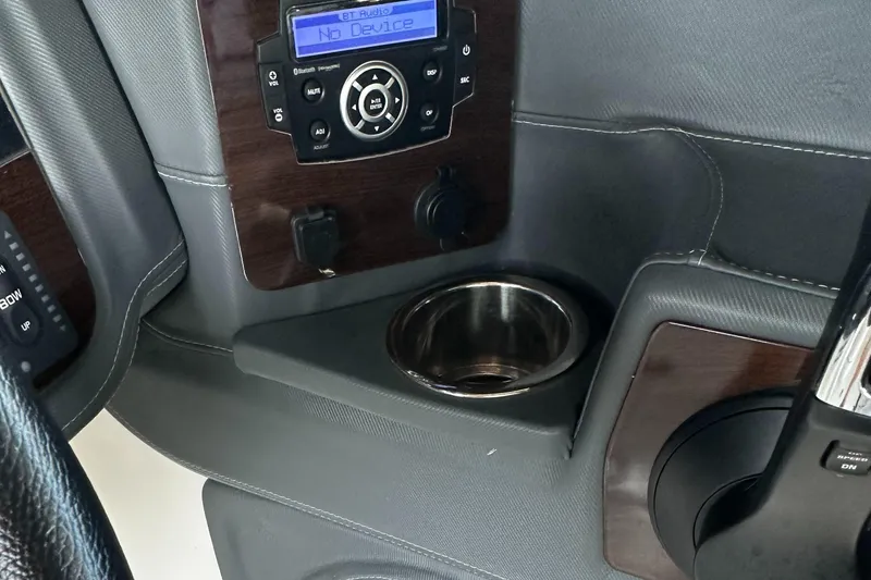 Slide: The Image of 2022 Chaparral 267 SSX OB dashboard with audio controls and cup holder. - 40