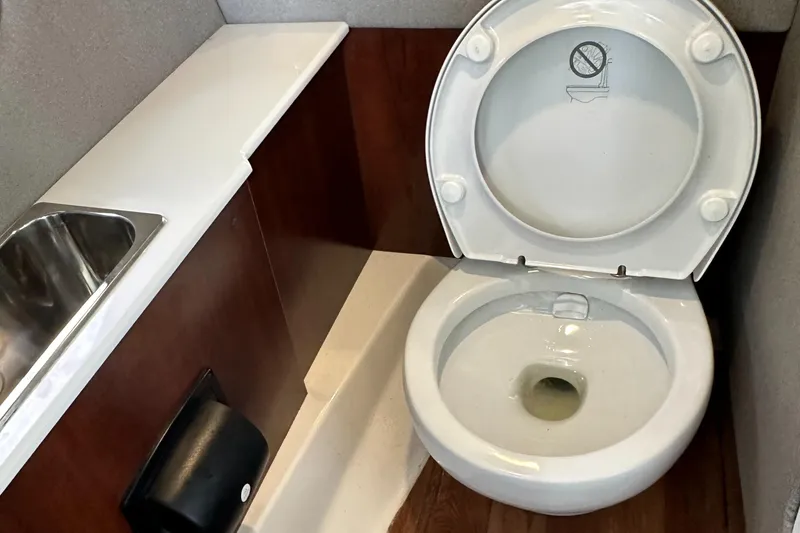 Slide: The Image of 2022 Chaparral 267 SSX OB boat bathroom with toilet and sink. - 41