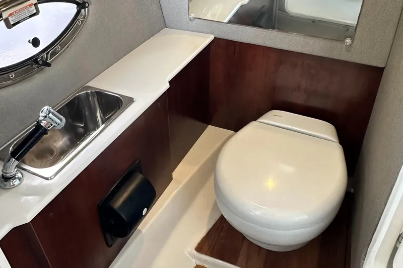 Slide: The Image of 2022 Chaparral 267 SSX OB boat bathroom with sink and toilet. - 42