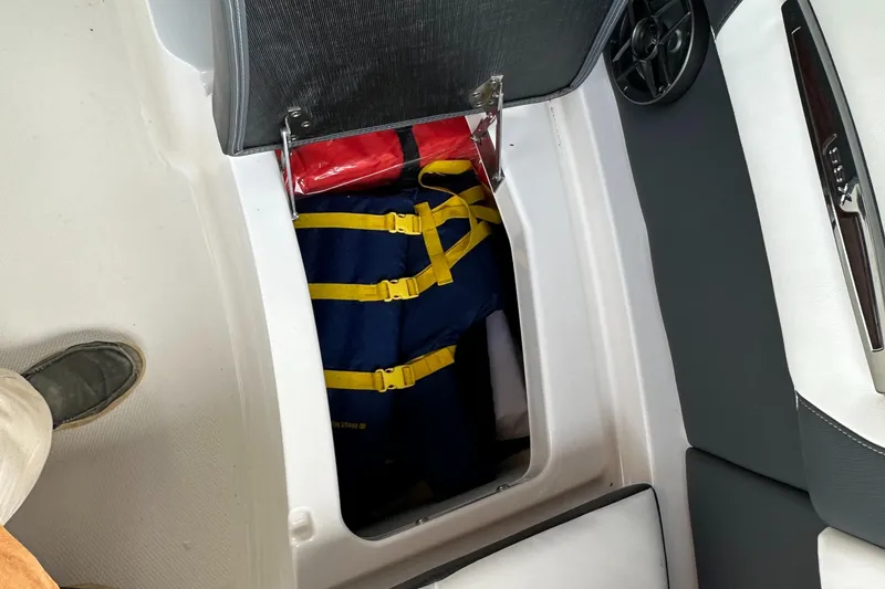 Slide: The Image of Storage compartment in 2022 Chaparral 267 SSX OB boat with life jackets. - 45