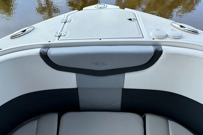Slide: The Image of 2022 Chaparral 267 SSX OB boat interior with cushioned seating and storage compartment. - 47