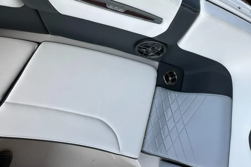 Slide: The Image of 2022 Chaparral 267 SSX OB boat interior with white and gray seating. - 48