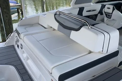 Slide: The Image of 2022 Chaparral 267 SSX OB boat interior with white seating and sleek design. - 7