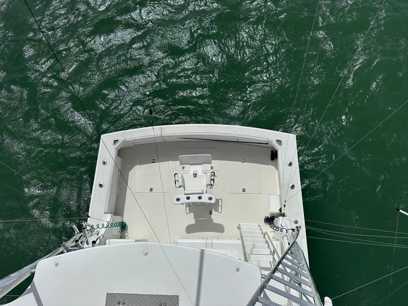 Slide: The Image of Bertram 50 Convertible 1990 yacht deck overlooking green ocean waters. - 10