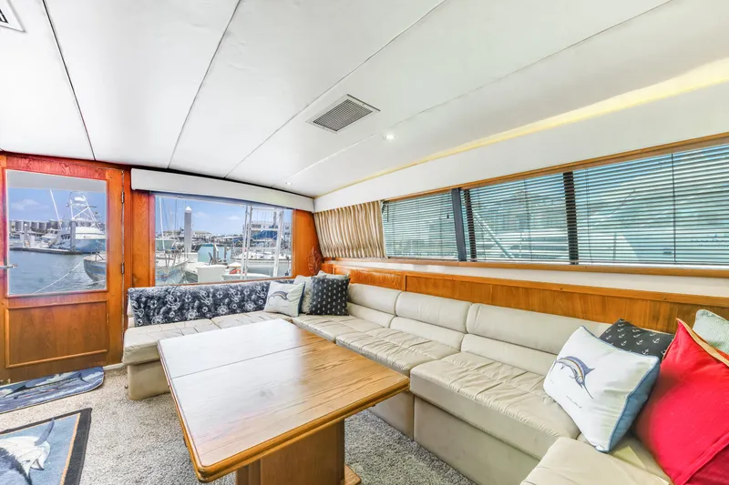 Slide: The Image of Luxurious interior of a 1990 Bertram 50 Convertible yacht with spacious seating and large windows. - 15
