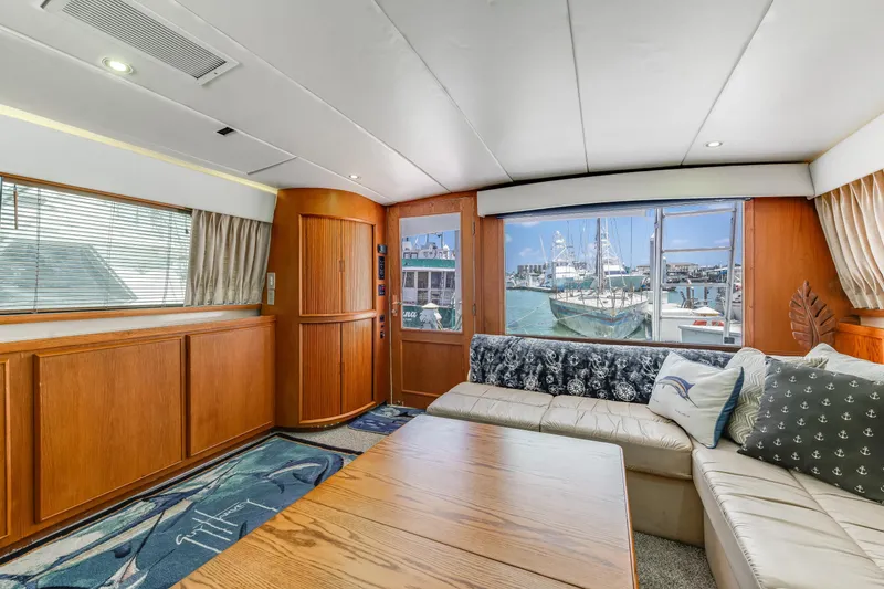 Slide: The Image of Luxurious interior of 1990 Bertram 50 Convertible yacht with marina view. - 16